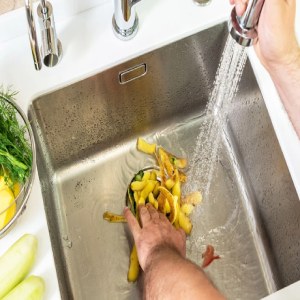 Plumbers Handling Garbage Disposal Waste